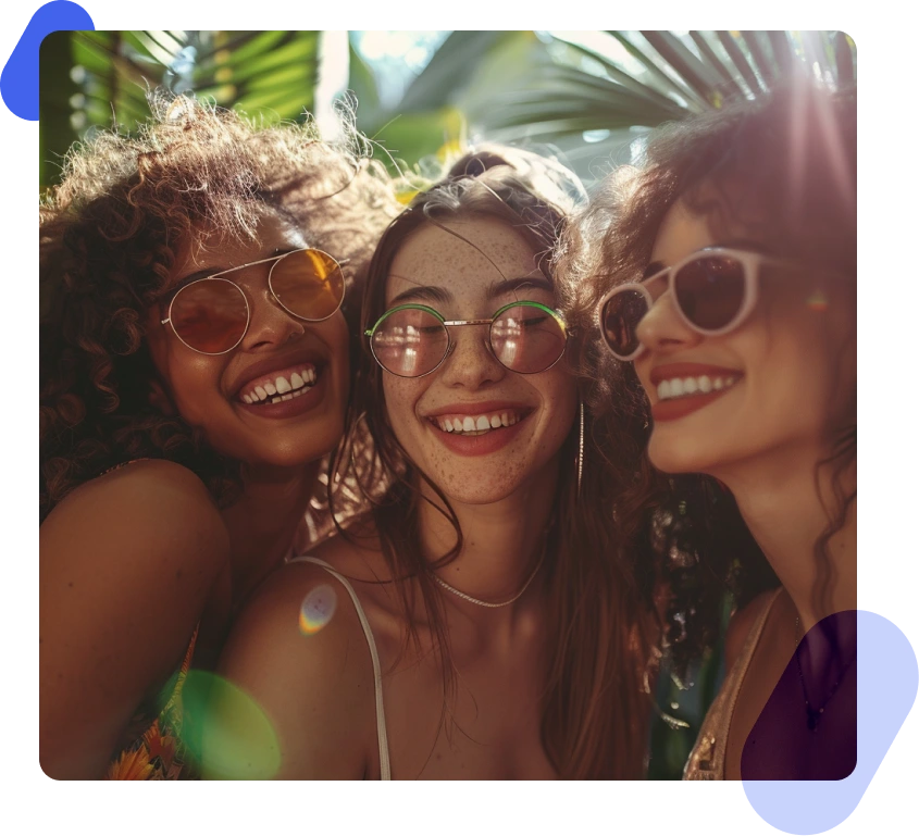 Photo of three women smiling, exuding happiness and positivity.